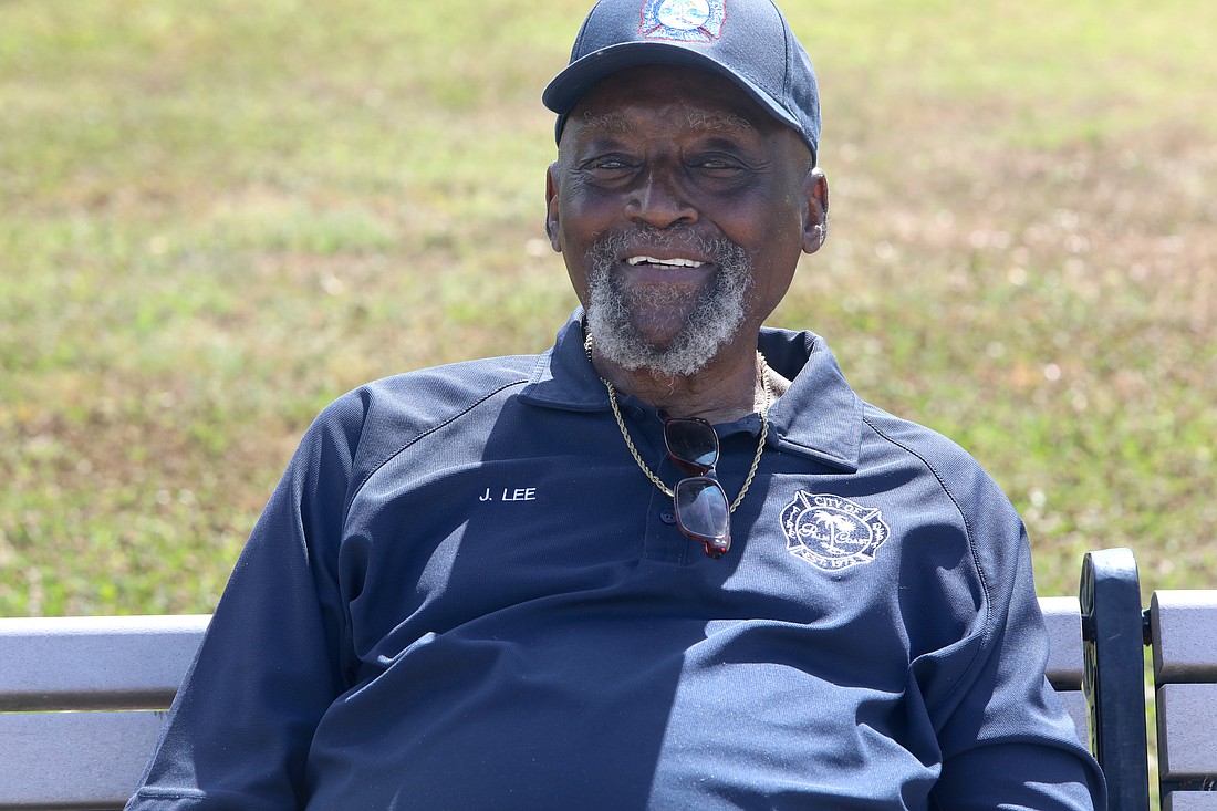 Jim Lee of the Palm Coast Fire Department rests on a bench at the Palm Coast Arbor Day celebration on May 4 at Central Park at Town Center. Photo by Brent Woronoff