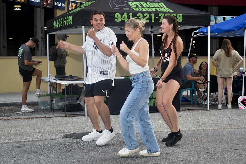 Former Circo manager Anthony Lopez, Ashley Jacusis and Julia King dance together at Circo.
