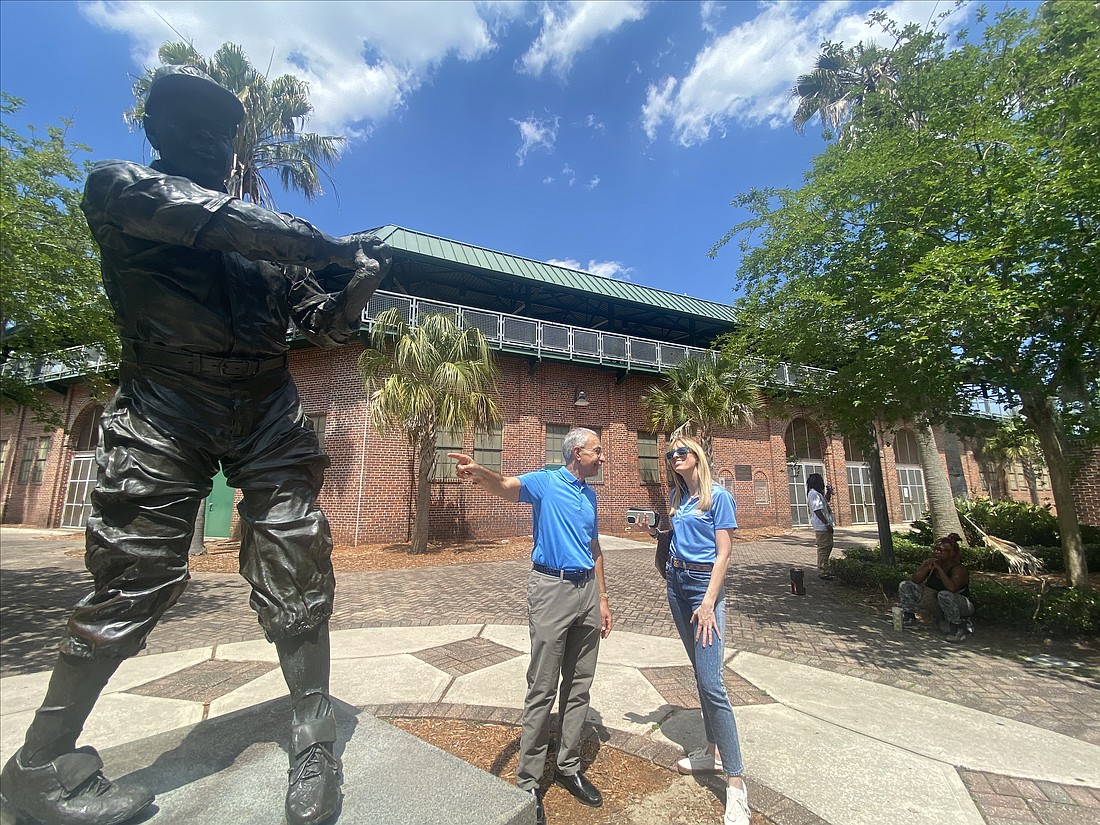 City Council President Ron Salem chats with his executive Council assistant, Nikki Evans, outside J.P. Small Memorial Stadium during a visit to the Durkeeville baseball park April 24. The statue Salem is pointing to depicts Baseball Hall of Famer John “Buck” O’Neil, who played at Edward Waters University on his way to a career in the Negro Leagues and as the first Black coach in Major League Baseball.