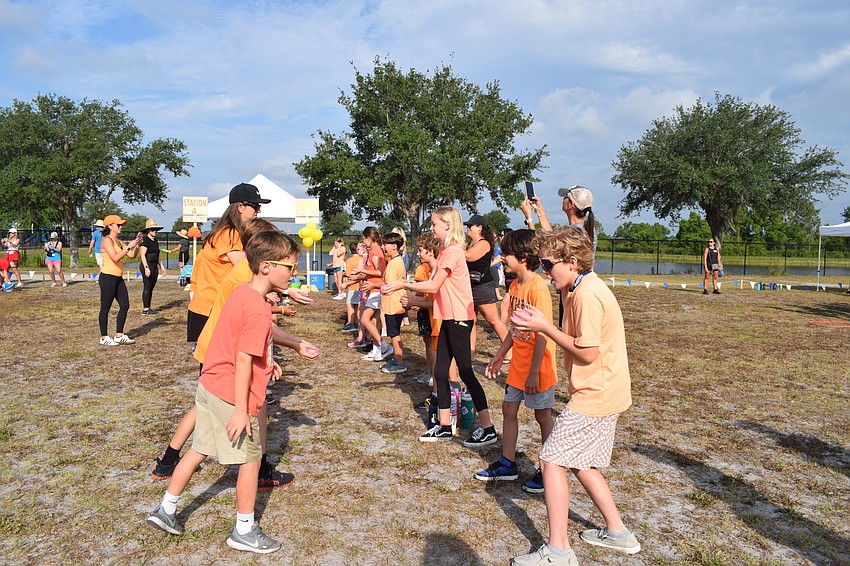Students are ready to test their tossing skills in a water balloon toss.