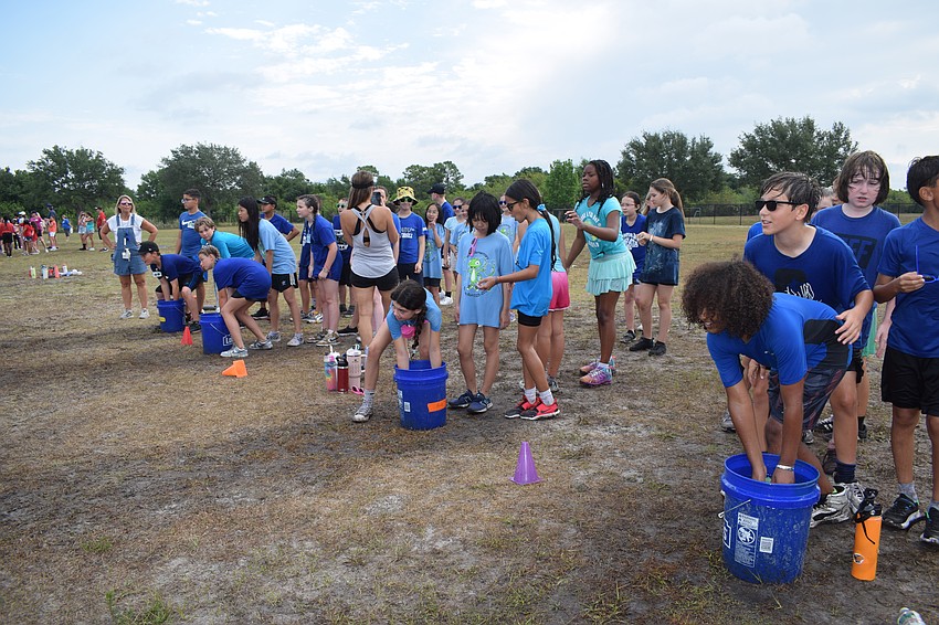 Students get ready for the start of the sponge relay race.