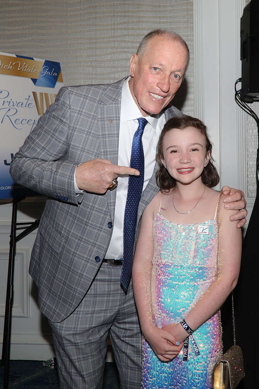 Pro football Hall of Fame member Jim Kelly, with cancer survivor Harper Harrell, who just rang the two-year bell in February.