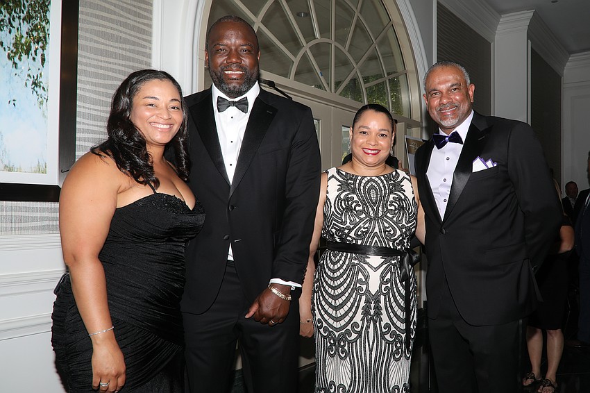 Cierra and Jareem Dowling with Careylyen and Jerome Tang — Jareem and Jerome are men's basketball coaches from Kansas State.