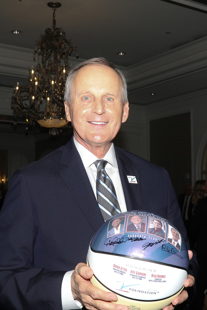 University of Tennessee men's basketball head coach Rick Barnes holds a freshly signed basketball at the Dick Vitale Gala.