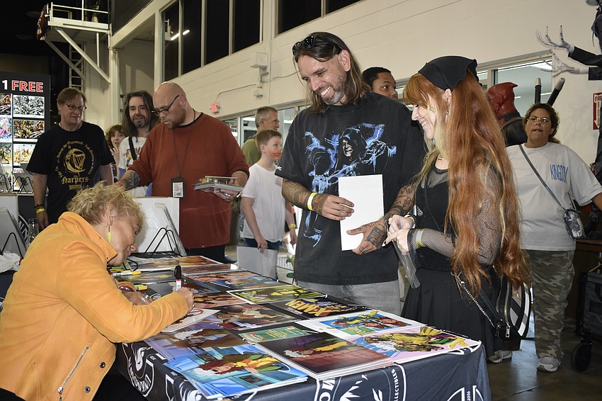 Lenore Zann, the voice of Rogue on the X-Men animated series which aired from 1992-1997, signs a picture for Raymond and Asia Macier.