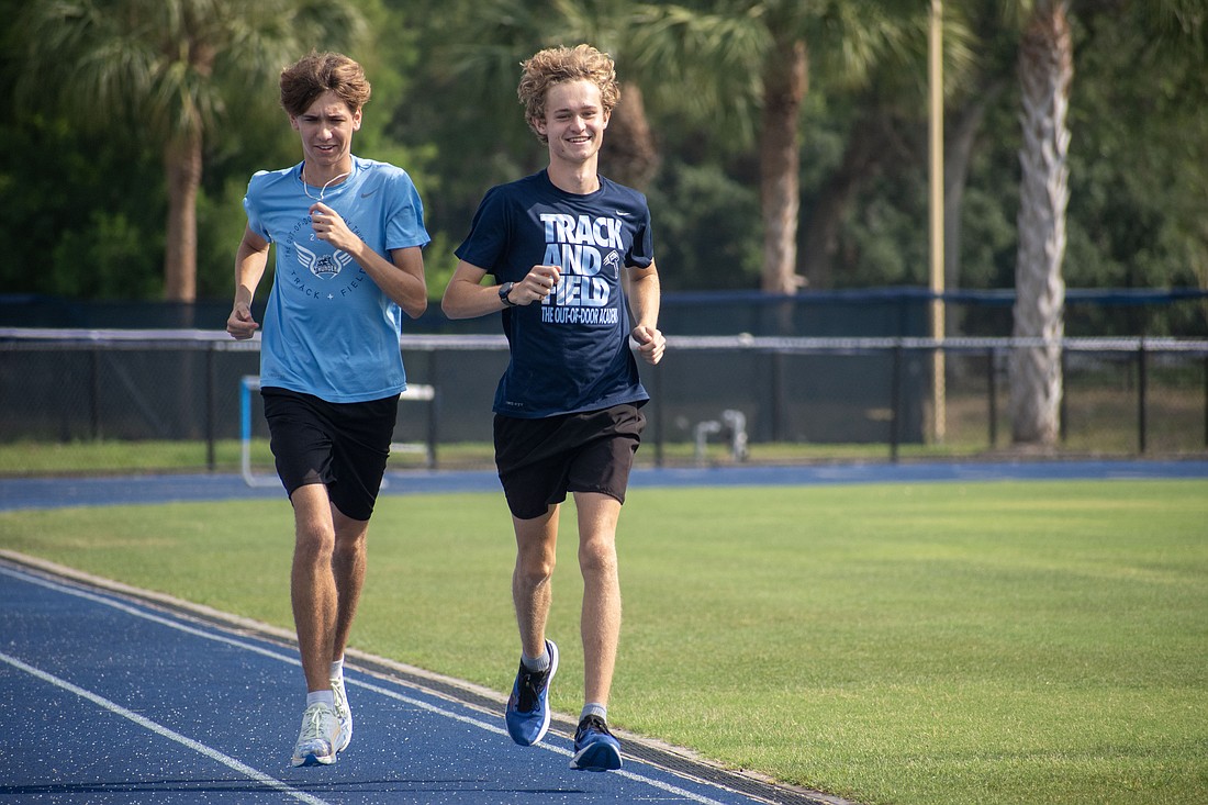 The Out-of-Door Academy sophomore Kevin Gyurka and junior Collin Dillingham prep for the state meet at a May 11 practice. Both runners have the chance to set school records at the meet, Gyurka in the 3,200-meter run and Dillingham in the 800-meter run.