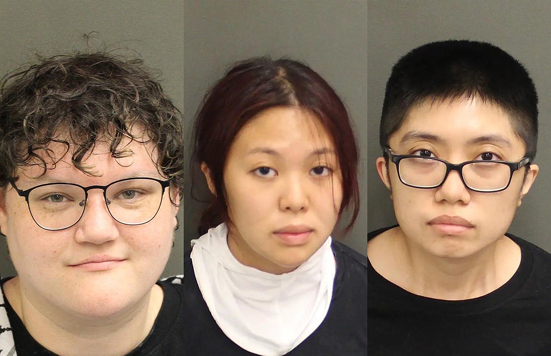 From left: Isabella Giannosa, 26, of Oviedo; Jenni Nguyen, 24, of Winter Garden; and My Truong, 24, of Oviedo, were arrested and transported to the Orange County jail.