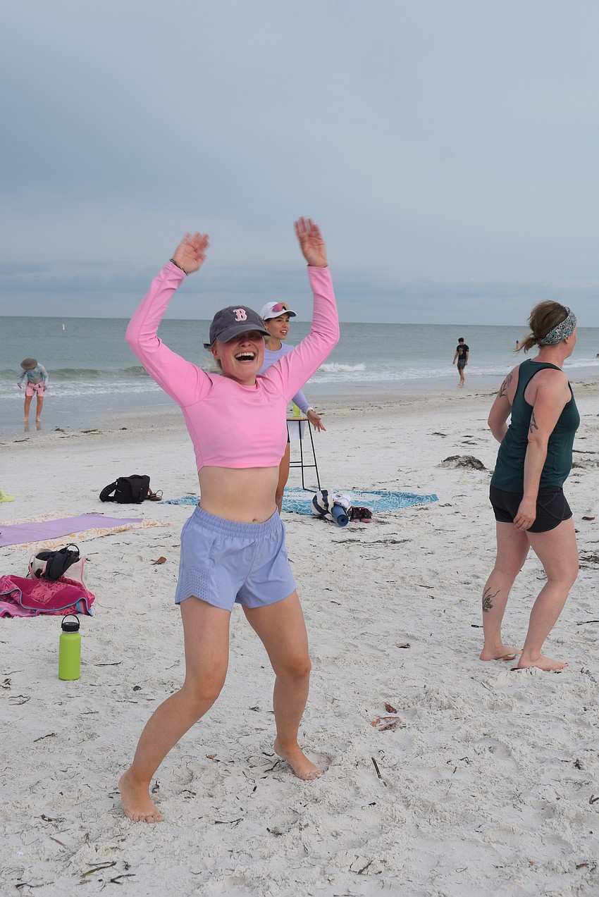 Sami Hobbs does jumping jacks while waiting for her mother Sonja Kaiser to finish lunges.