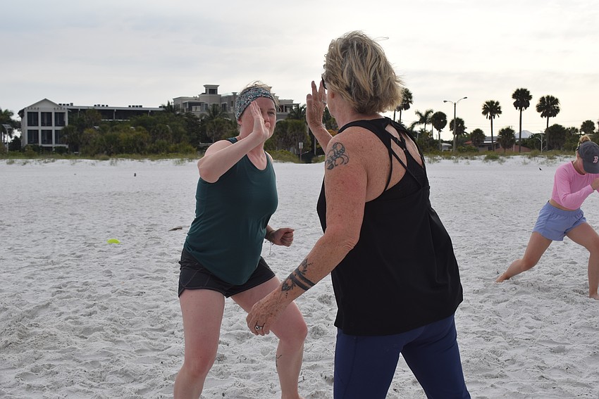 Jamie McDermott-Galles and Jill Gilfillan Bower switch off during a relay race.