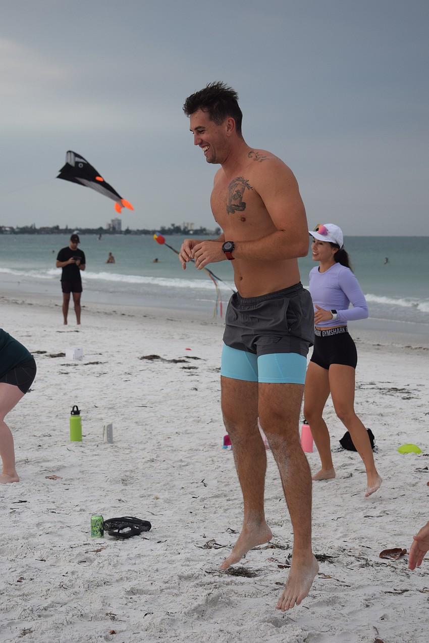 Westley Adelman does squat jumps while he waits for his mother Christine to finish her exercise.