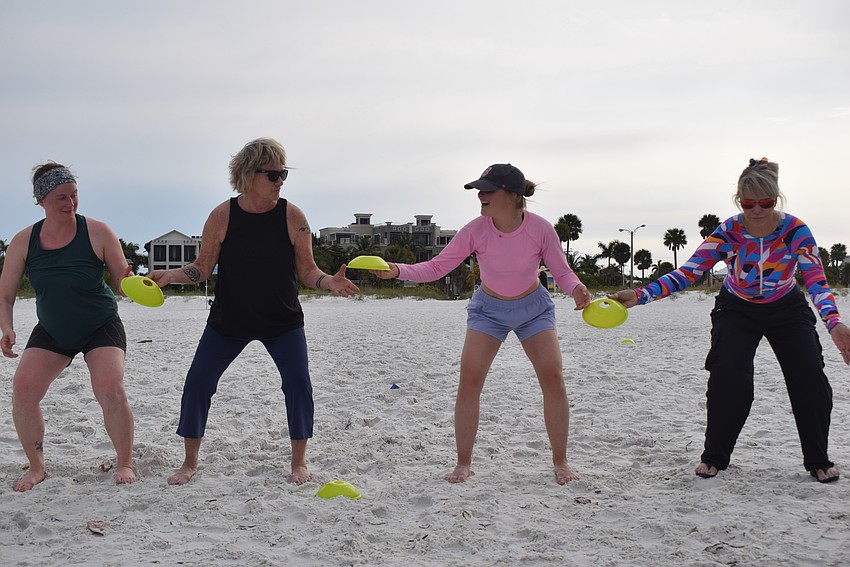 This team-building exercise involved passing the cones to each other as fast as they could while squatting. Once all the cones were passed, the women went down into a plank.