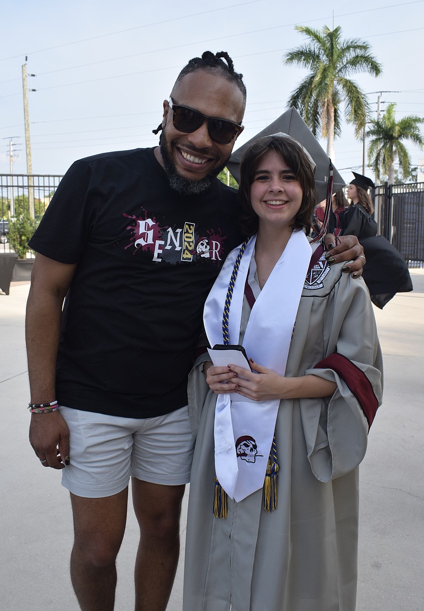 Ricardo Robinson-Shinall, the drama teacher at Braden River High, congratulates Cat DeMocko.