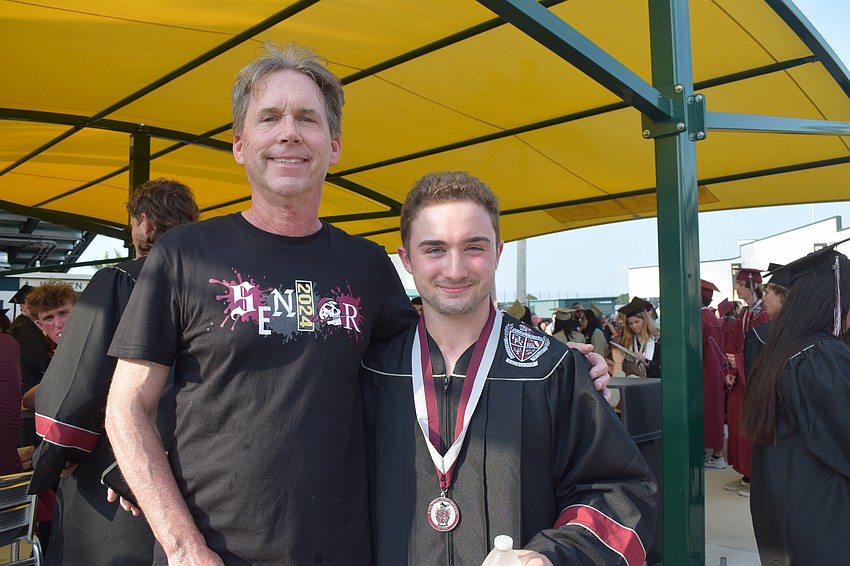 James Straub, a Braden River High math teacher, congratulates his student, Jacob Karam. 