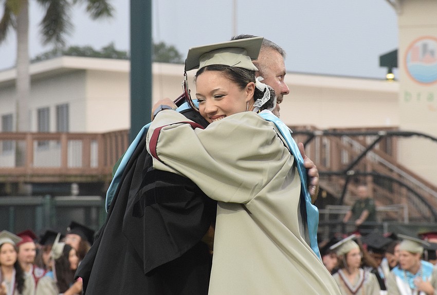 Braden River High graduate Adanna Wharton hugs Principal Carl Auckerman. Wharton will go to Embry-Riddle Aeronautical University.