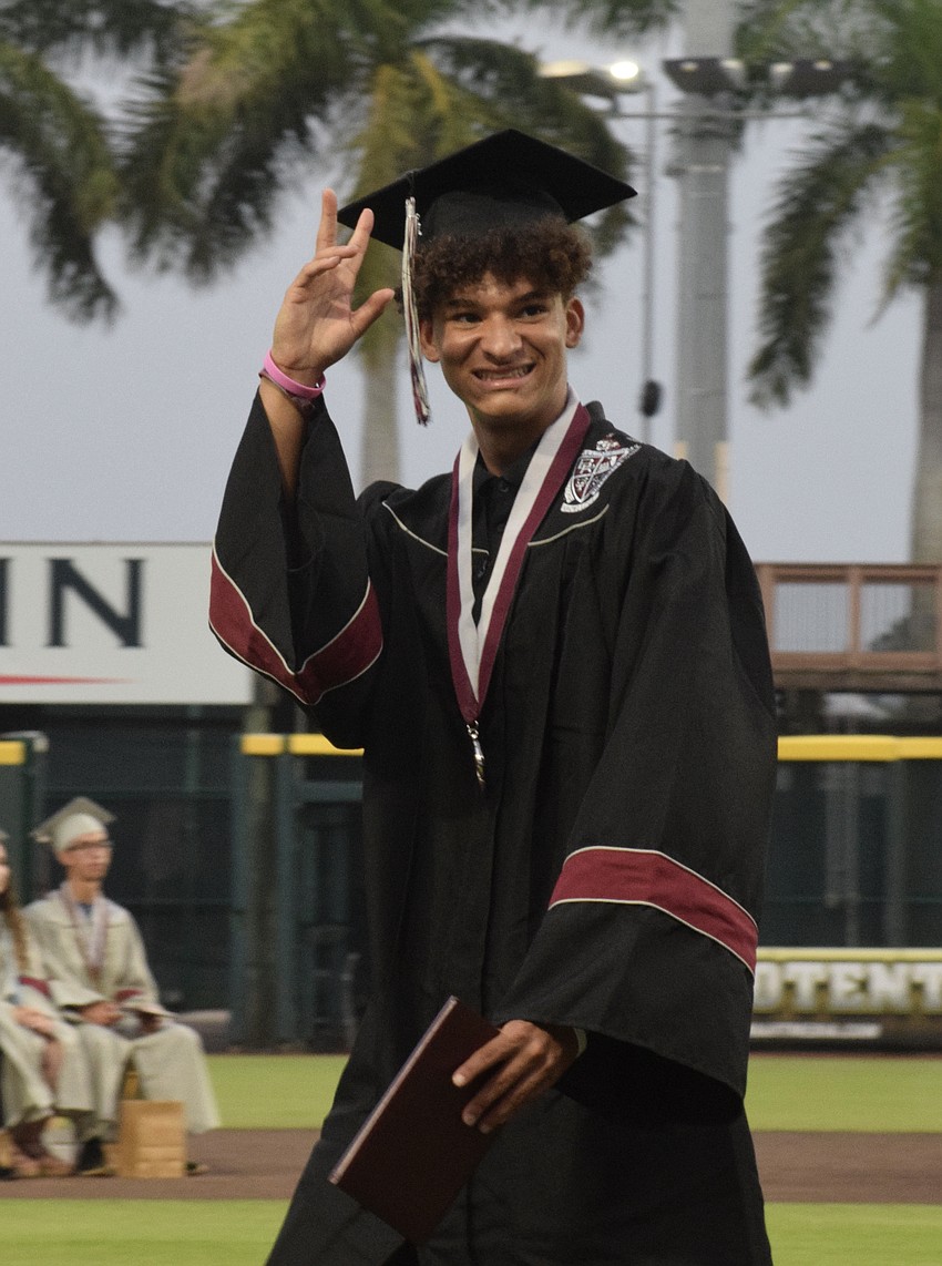 Braden River High graduate Dylan Brown waves to the audience after receiving his diploma.