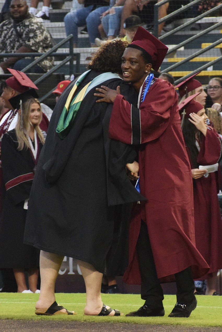 Braden River High Assistant Principal Rebecca Austerman hugs graduate Princton Davis.