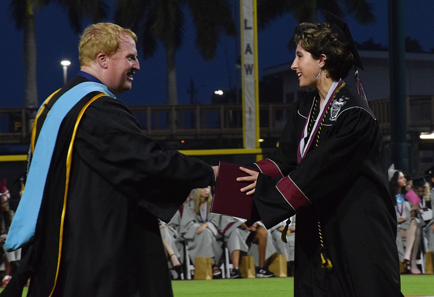 Jason Wysong, the superintendent of the School District of Manatee County, congratulates Braden River High graduate Tiffany Rock.