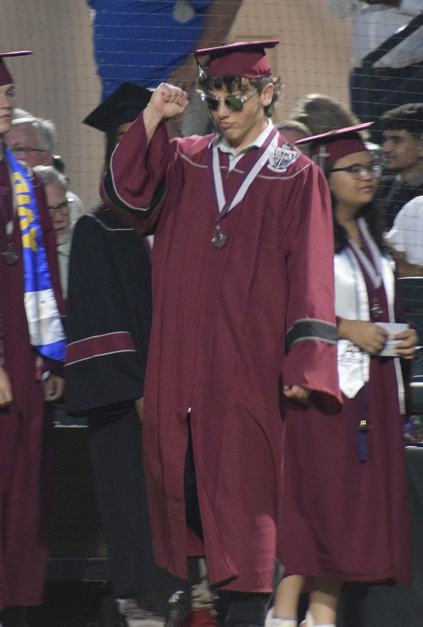 Braden River High graduate Hunter Seavey pumps his fist as he makes his way across the field.