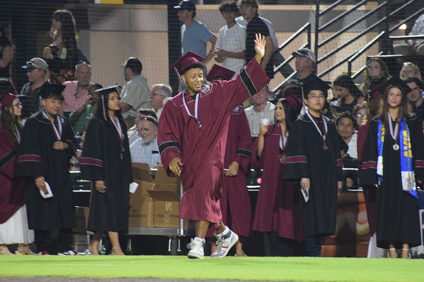 Braden River High graduate Jainel Torrado waves to his family in the audience.