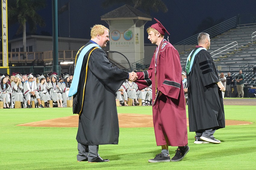 Last but not least, Jason Wysong, the superintendent of the School District of Manatee County, congratulates the final Braden River High graduate, Nicholas Zygmunt.
