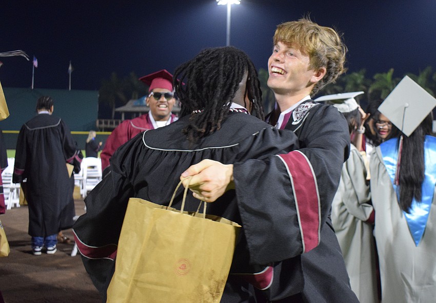 Braden River High graduates Micah Fedd and Kyle Langley hug after the ceremony.