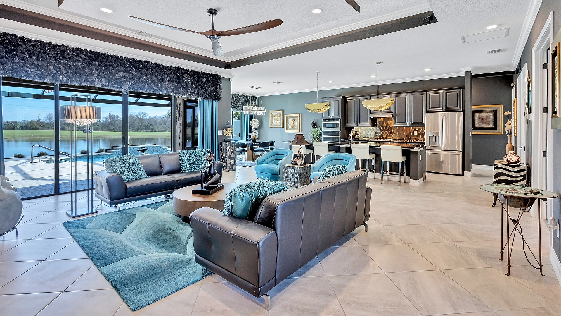 A dramatic mix of colors enlivens the open concept living area, with equally dramatic views of the lake and golf course out past the swimming pool.