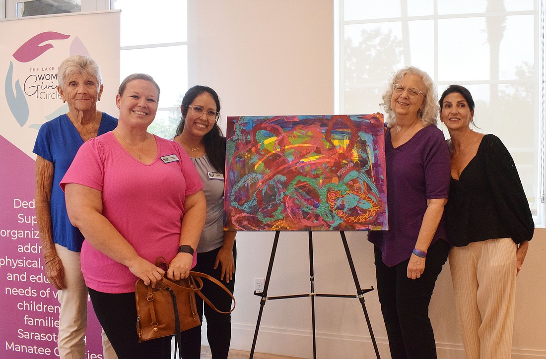 Lake Club Women's Giving Circle's Nancy Lepain, Hope Family Service's Tiffany Ogline and Daviana Ferrer, Lake Club Artist Guild founder Margie Meyer and Lake Club Women's Giving Circle's Barbara Najmy work together to donate artwork to Hope Family Services.