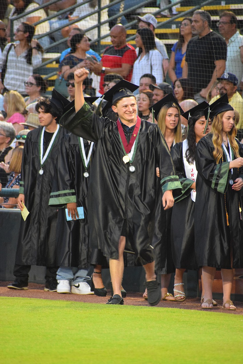 Wesley Geiger, a Lakewood Ranch High School, celebrates on his way to receiving his diploma.