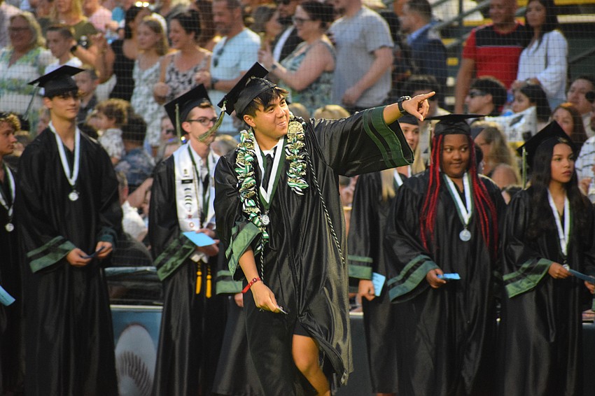 Lakewood Ranch High School's Dominic Javate points to his family in the audience before accepting his diploma.