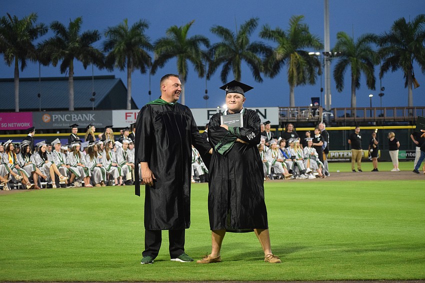 Dustin Dahlquist, the principal at Lakewood Ranch High School, laughs as Andrew Lazinek strikes a pose for their photo together.