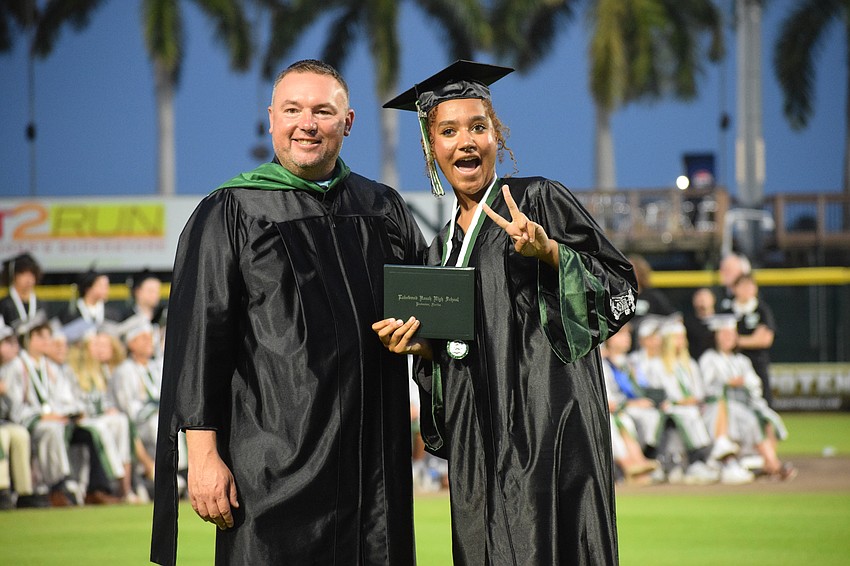 Dustin Dahlquist, the principal at Lakewood Ranch High School, congratulates Karina Lee.