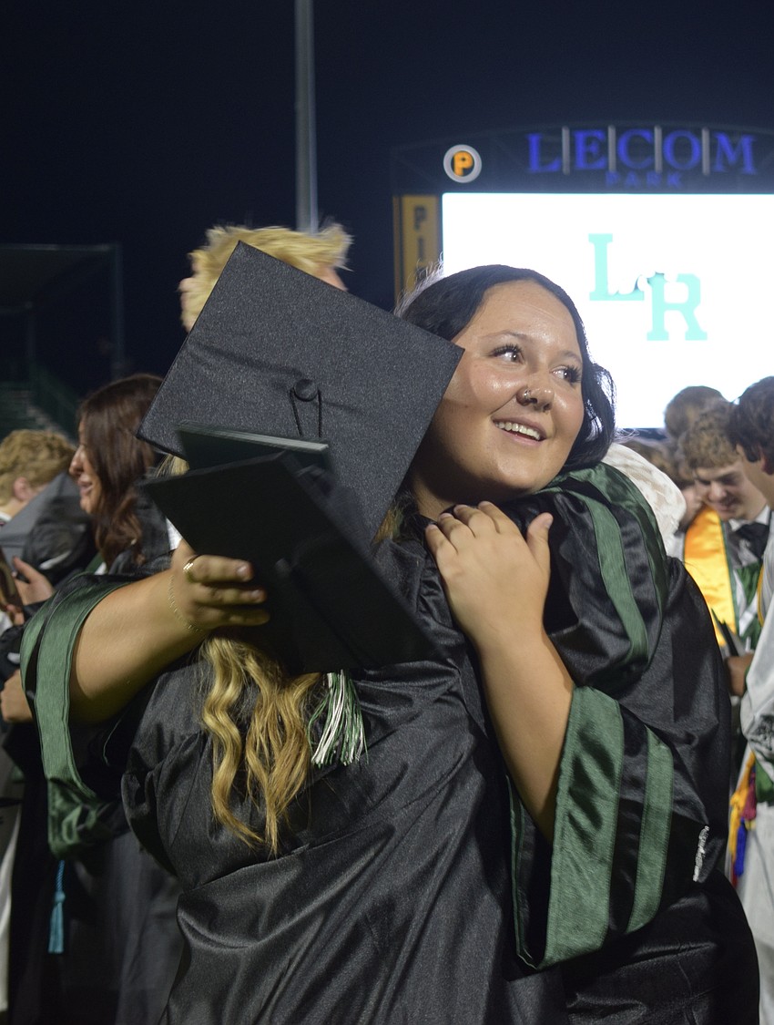 Vanessa Sellmer hugs Ava Horne to celebrate their graduation from Lakewood Ranch High School.