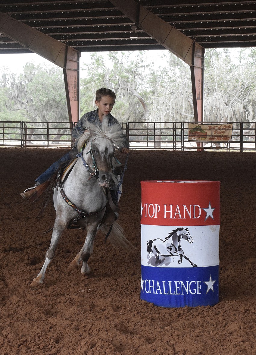 Eli Masse does his best to get his horse around the barrels as fast as possible in the barrel race. He completed the race in 40.851 seconds.