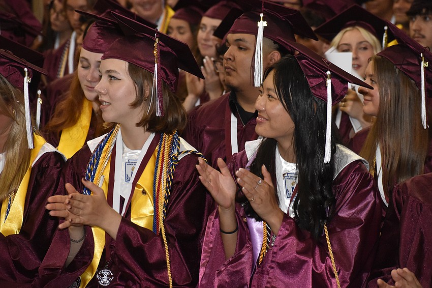 Sydney Lemz and Ellee Liang applaud during the ceremony.