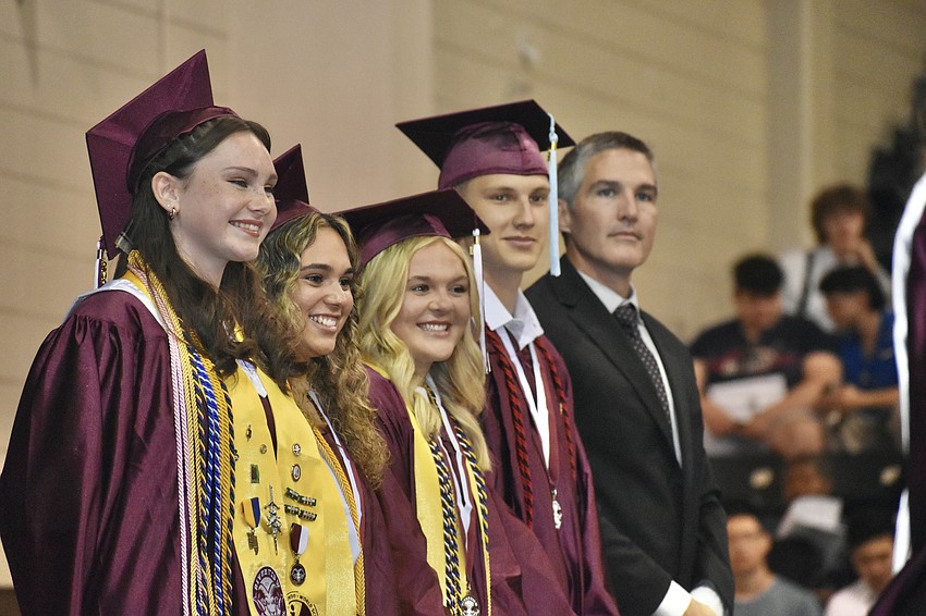 Senior class vice president Molly McWilliams, secretary Lea Hernandez-Bower treasurer, Alyssa Gancitano, historian Samuel Woods and sponsor Josh Mocherman stand to be recognized.