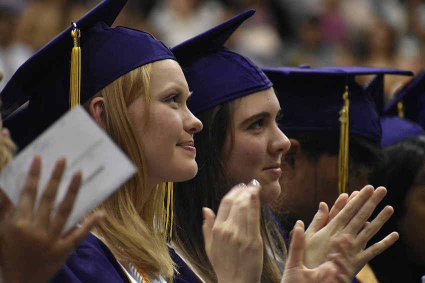 Sophia Chursina and Scarlett Jane Whisnant applaud during the ceremony.