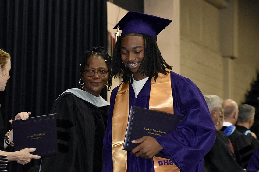Rachel Shelley stands beside Damien Chestnut-Simmons as he departs the stage.