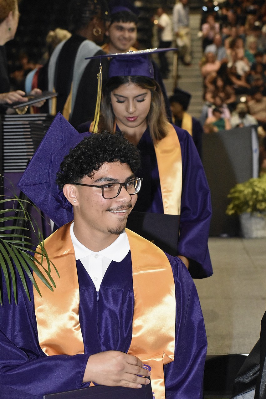 Patricio, Leah and Edwin Rodriguez make their way across the stage.