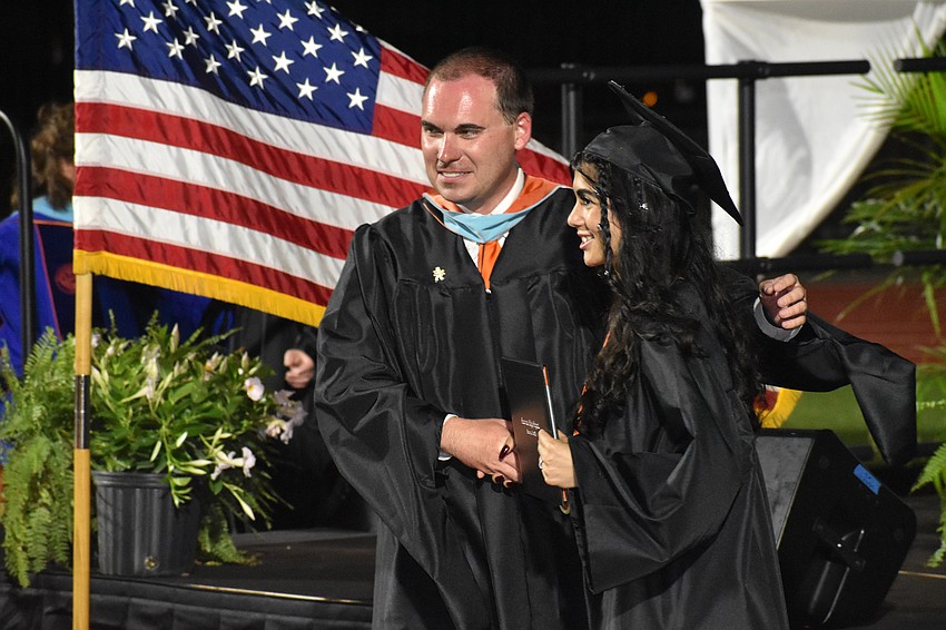 Principal Ryan Chase greets Emma Sasville