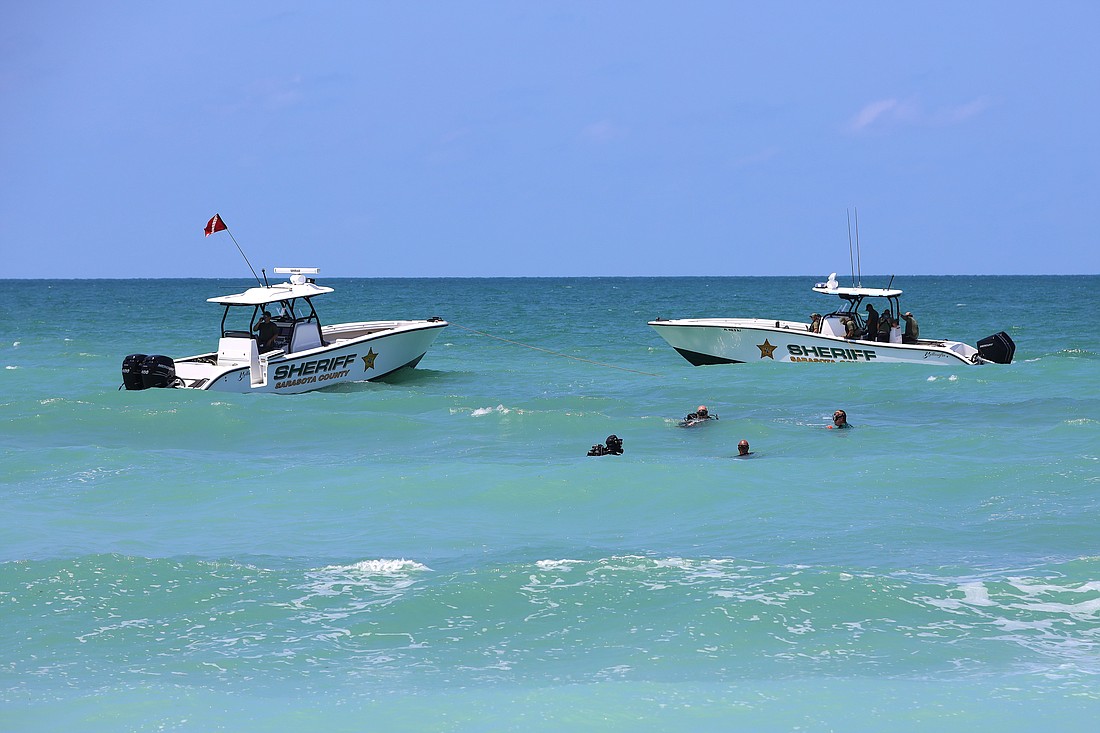 The Sarasota County Sheriff's Underwater Recovery Force and marine unit searches for a missing swimmer near Turtle Beach on May 20, 2024.