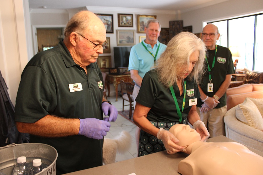 CERT instructor Pat Knowles directs Cynthia Olcott on the proper way to clear an airway during a refresher course May 17 in Summerfield.