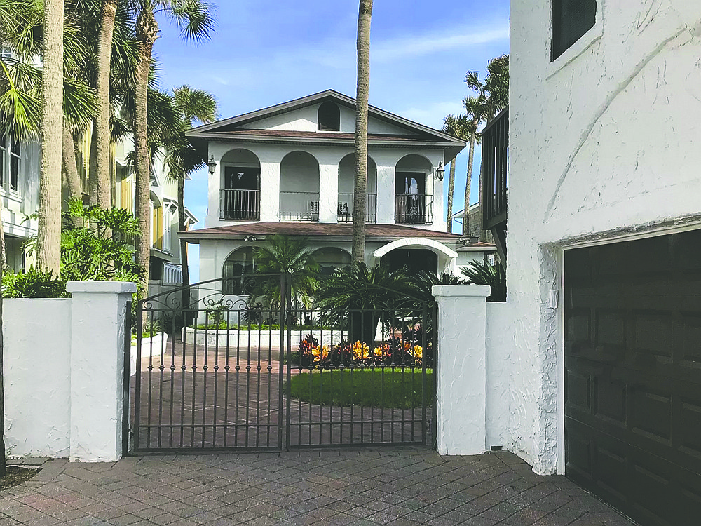 Oceanfront Mediterranean-style two-story home features six bedrooms, five bathrooms, office, porches, balcony, pool, patio and two-story guesthouse with garage.