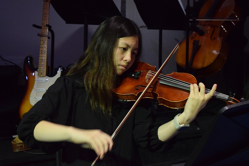 The Out-of-Door Academy junior Selina Zhang plays violin during the graduation ceremony.