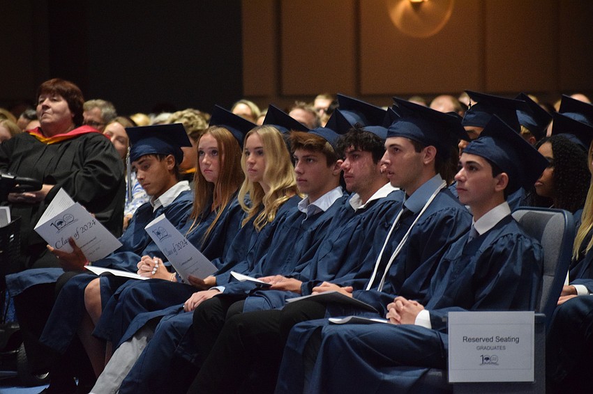 Graduates listen to their classmate Trey Naese give his speech as valedictorian.