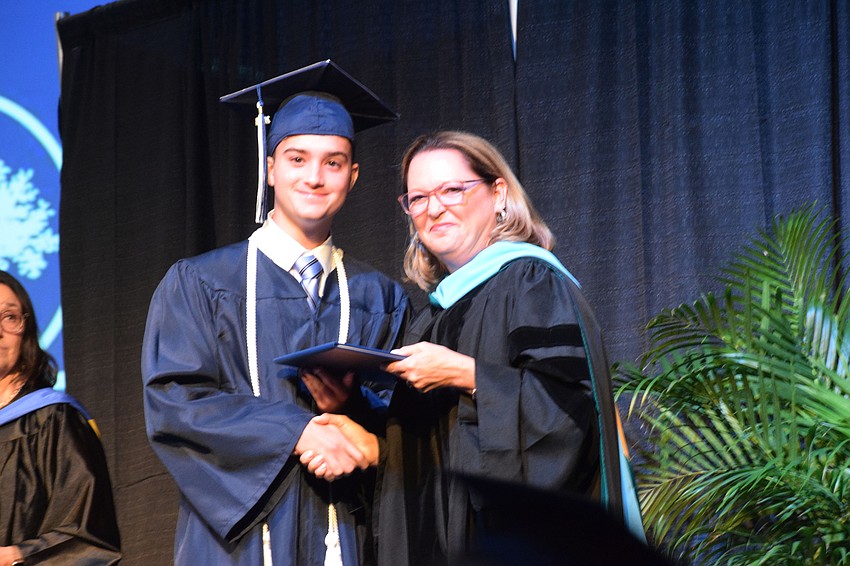 Joaquin Garcia Argibay beams with pride as he accepts his diploma from Head of School Deb Otey.