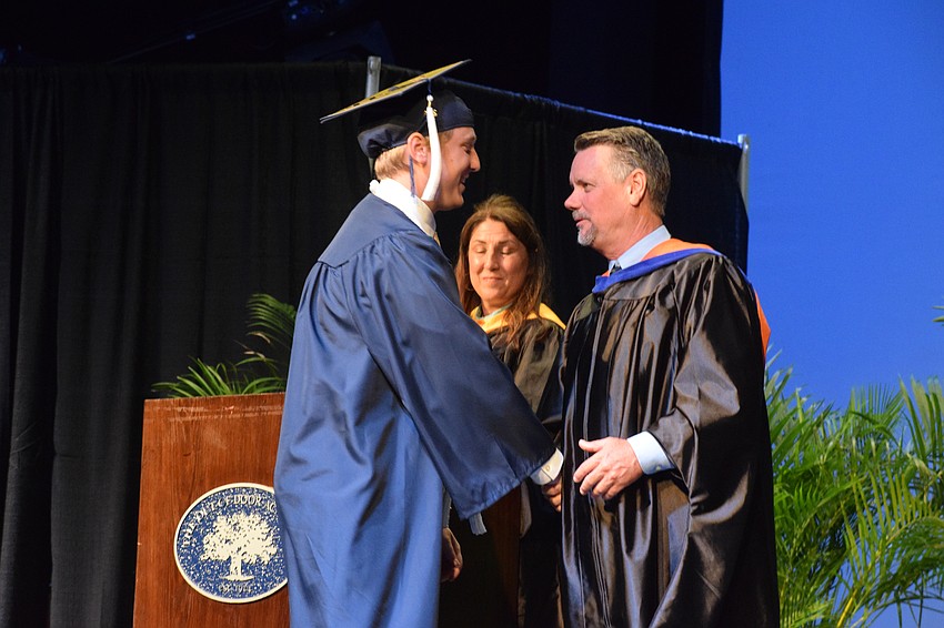 Trey Naese, the valedictorian, is congratulated by Sean Ball, the head of the upper school.