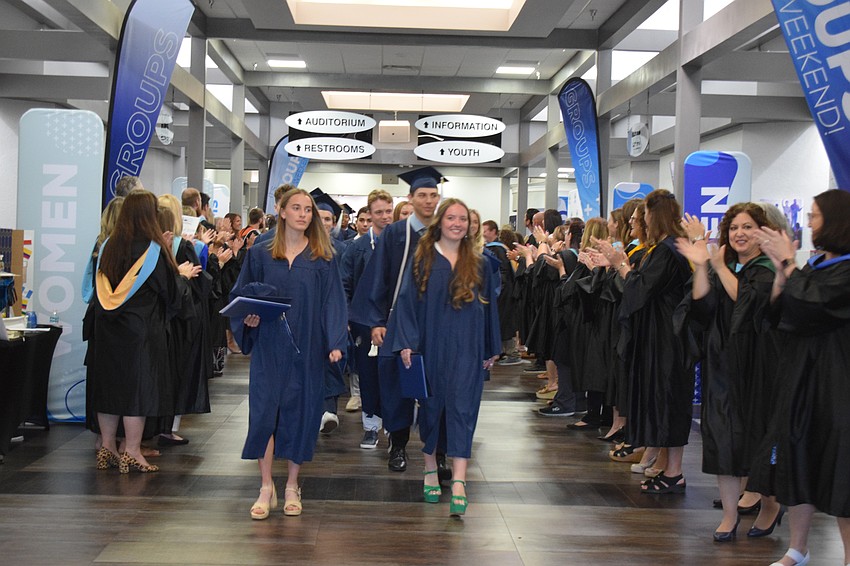 The Out-of-Door Academy faculty and staff cheer for graduates after the ceremony.