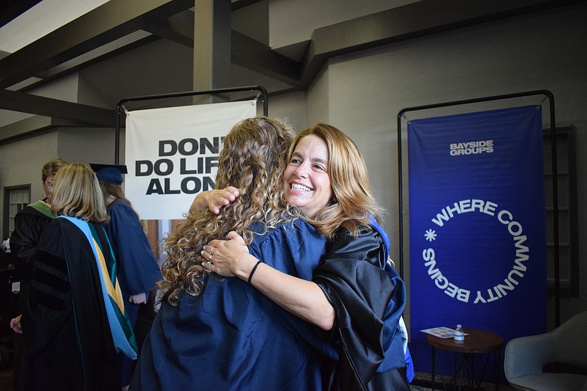 Melinda Lloyd, an upper school counselor, congratulates and says goodbye to a graduate.