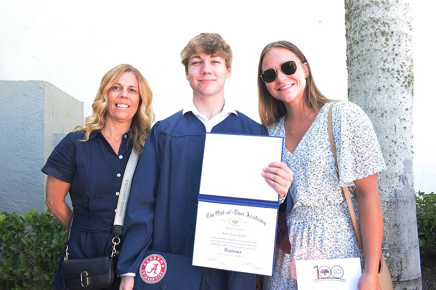 Amy Tribble celebrates with graduate Kaden Tribble and Caroline Przystup.