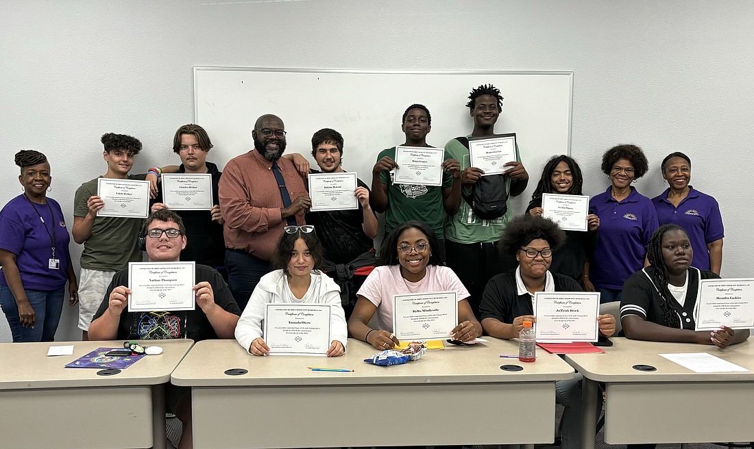 Students hold up their certificates after completing the Inspiration of Hope Community Resources Life Skills sessions at the George Washington Carver Center. Courtesy photo